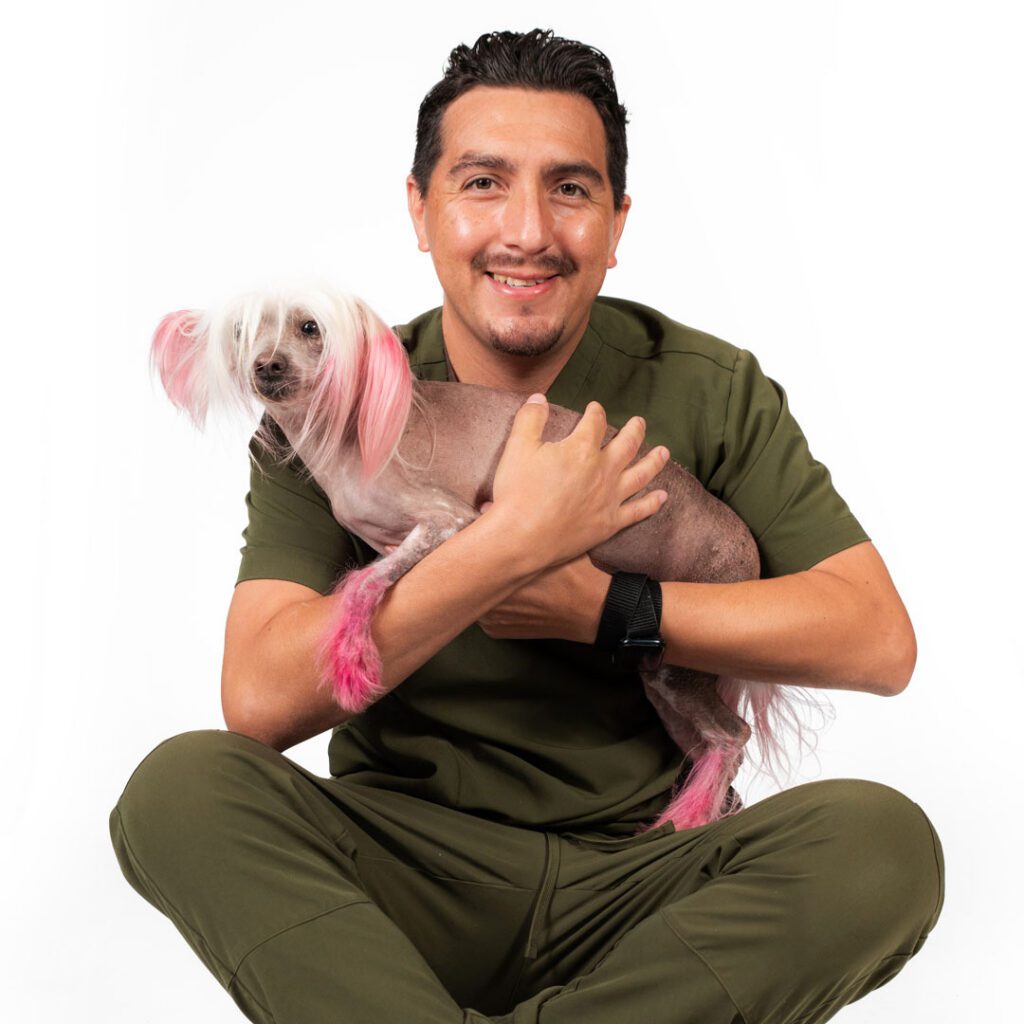 smiling young man holding a small dog