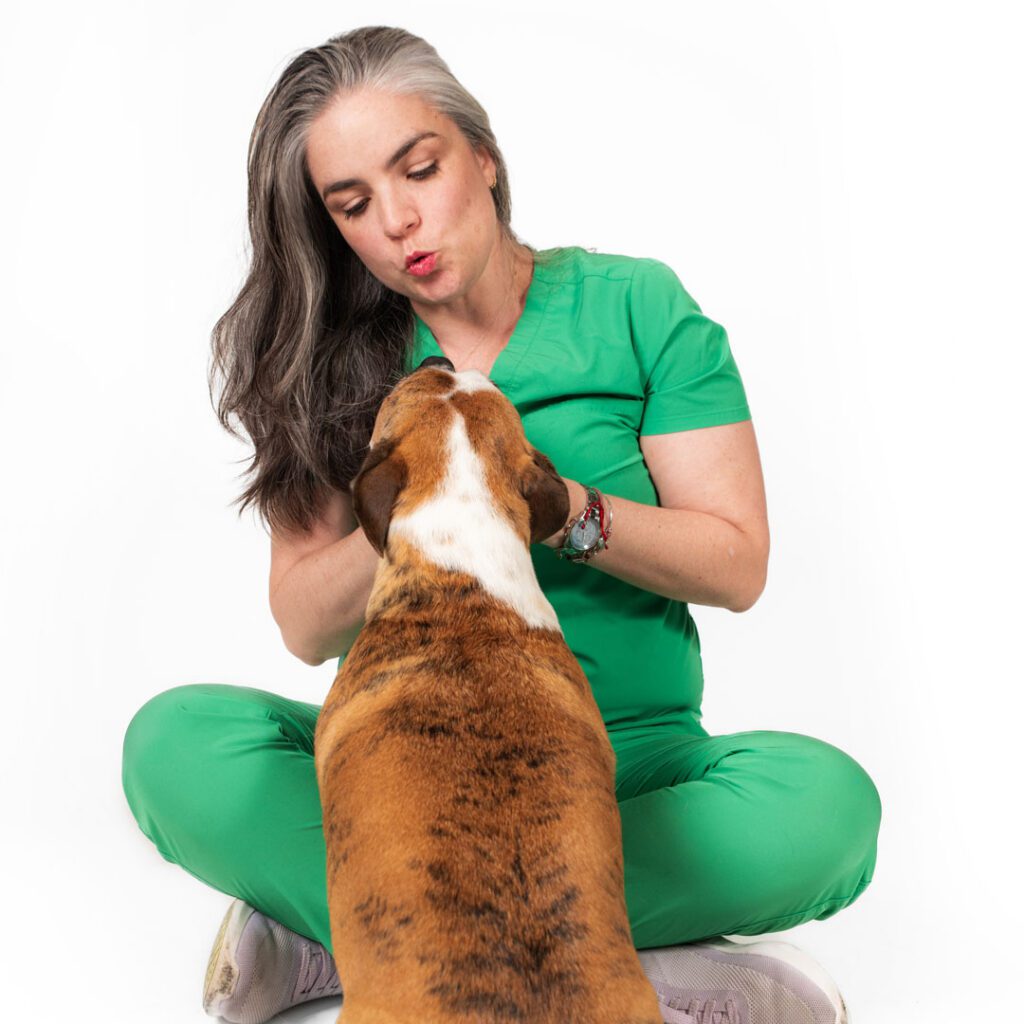 female veterinarian sitting with dog